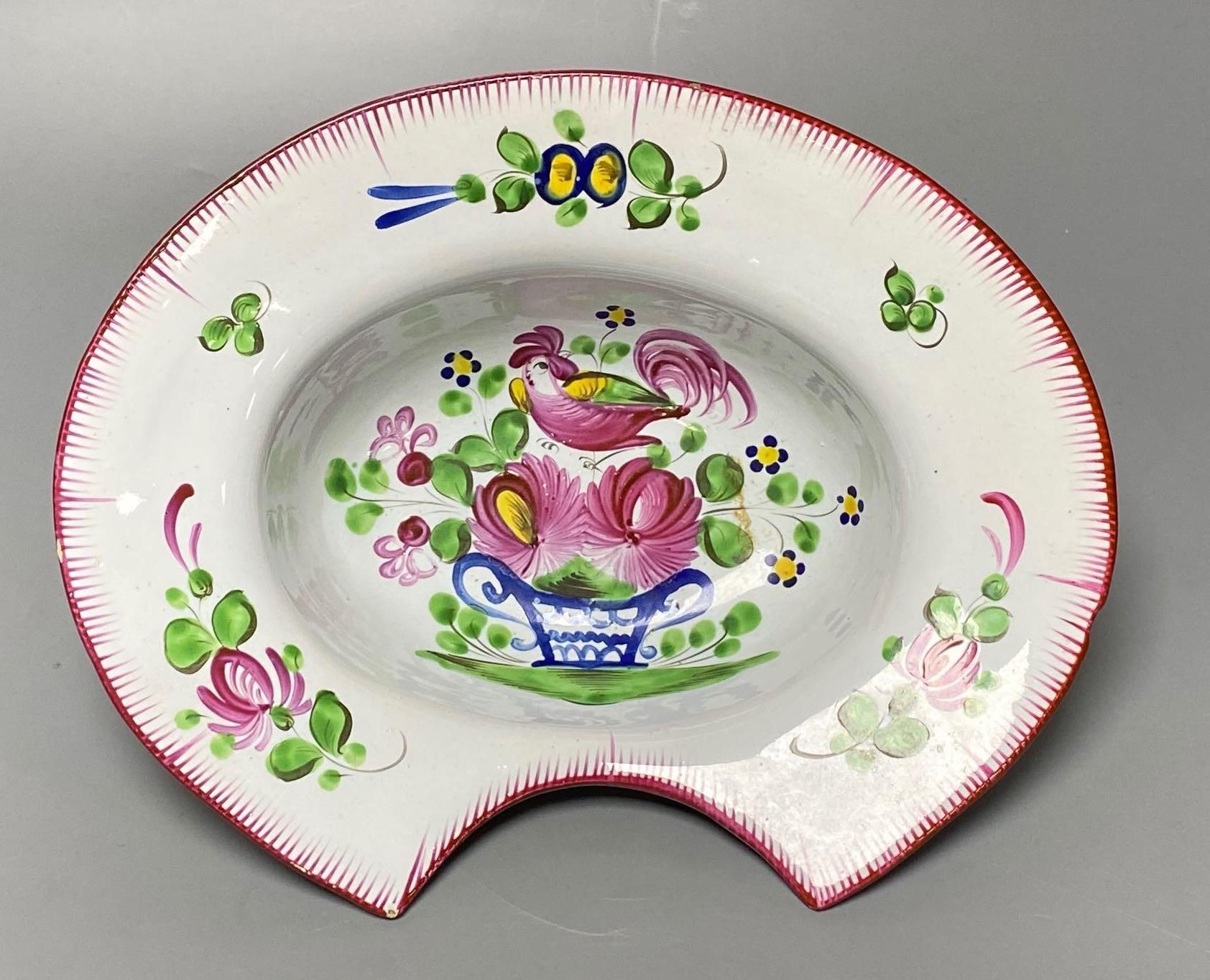 An early 19th French faience barbers bowl, brightly enamelled, width 26cm